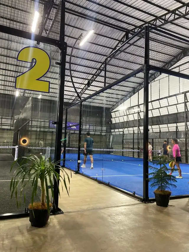 Court 2 at The Padel Side, blue turf under a steel roof