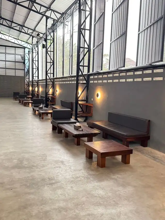 Row of sofas and wooden tables along the courts